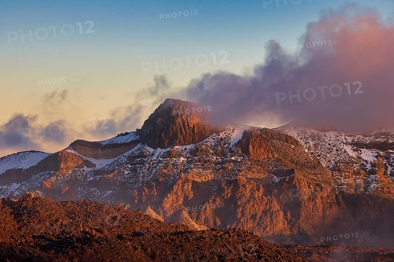 Rugged mountain landscape in the light of the setting sun, surrounded by clouds, UNESCO World Heritage Site, Teide National Park, Tenerife, Canary Islands, Spain