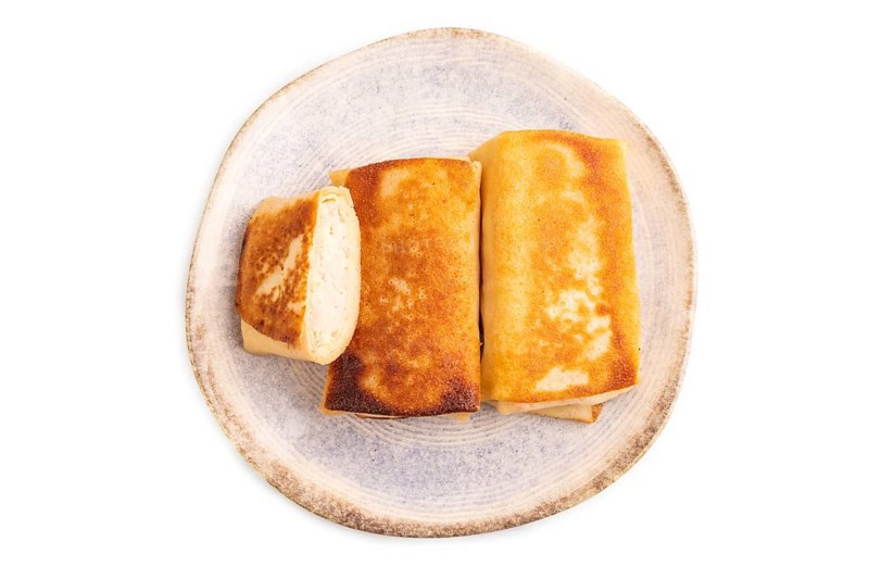 Fried crispy pancakes with meat and cheese isolated on white background. side view, copy space