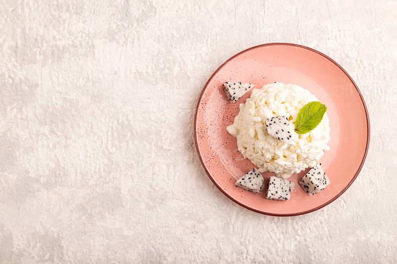 White ?ottage cheese, Curd, with Pithaya on gray concrete background, top view, flat lay, copy space