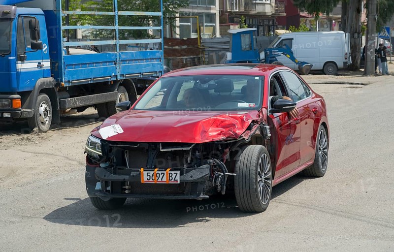 Close-up of red car with frontal damage on the road, Georgia