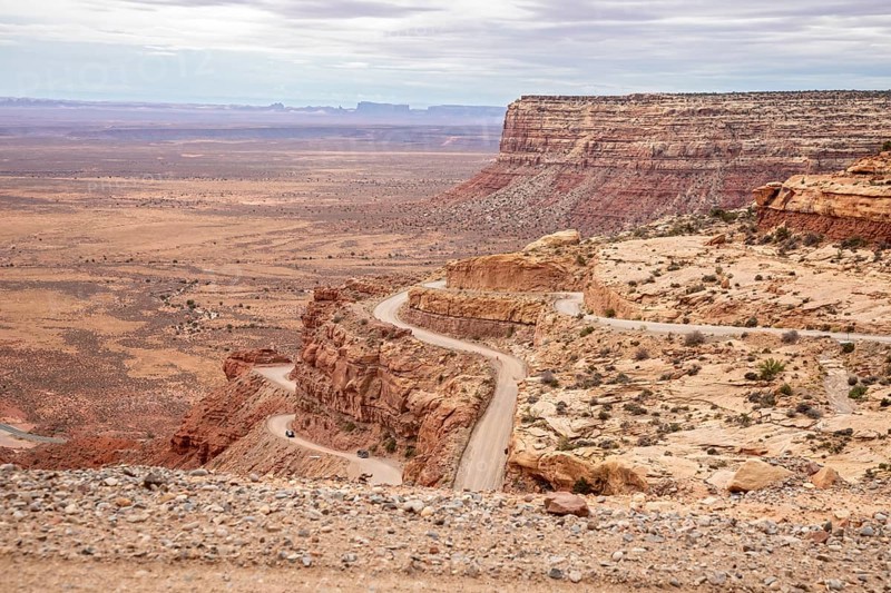 Mexican Hat, Utah - The Moki Dugway, an unpaved road with tight curves and no guardrails which descends 1200 feet from Cedar Mesa. The road was built in the 1950s to transport uranium ore from the mine to a mill