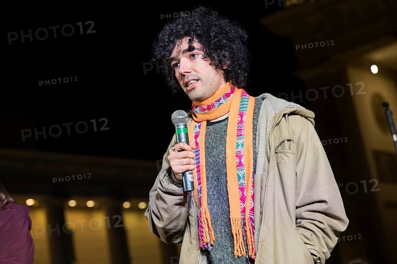 Arshak Makichyan (Russian-Armenian climate activist) speaks at the international climate demo under the motto Fight for 1.5 at the Brandenburg Gate in Berlin on 14.11.2025. The demonstration takes place on the occasion of the COP30 World Climate Conference in Belém, Brazil, and to mark 10 years of the Paris Climate Agreement