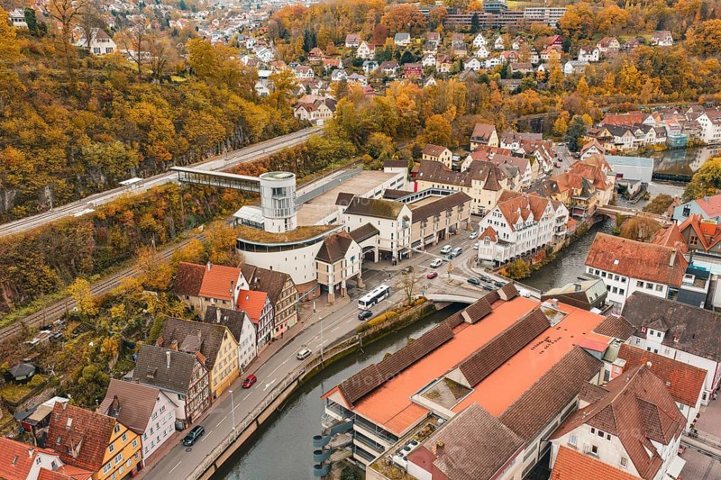 Aerial view of an urban environment with tower, roads and autumn landscape, Hermann Hessebahn, ZOB Calw, Germany
