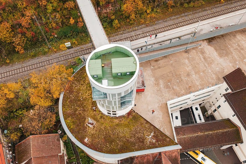 Tower with balcony and parking area, surrounded by autumn leaves and railroad tracks, Hermann Hessebahn, ZOB Calw, Germany