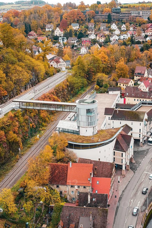 View of urban area with tower and railway tracks in autumn surroundings, Hermann Hessebahn, ZOB Calw, Germany