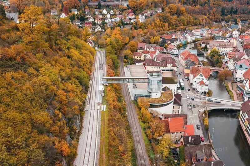 Panoramic view of railway tracks, city and river, with central tower in autumn, Hermann Hessebahn, ZOB Calw, Germany