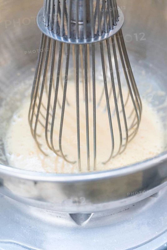 A metal whisk mixes a white mass in a metal bowl, Christmas baking, Haselstaller Hof, Wildberg, Germany