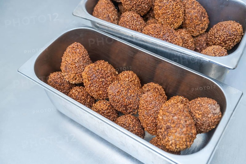 Metal container full of chocolate-coated balls in a professional kitchen, Christmas baking, Haselstaller Hof, Wildberg, Germany