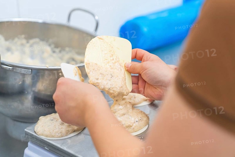 Two hands working with a dough and a silicone spatula on a kitchen table, Christmas baking, Haselstaller Hof, Wildberg, Germany