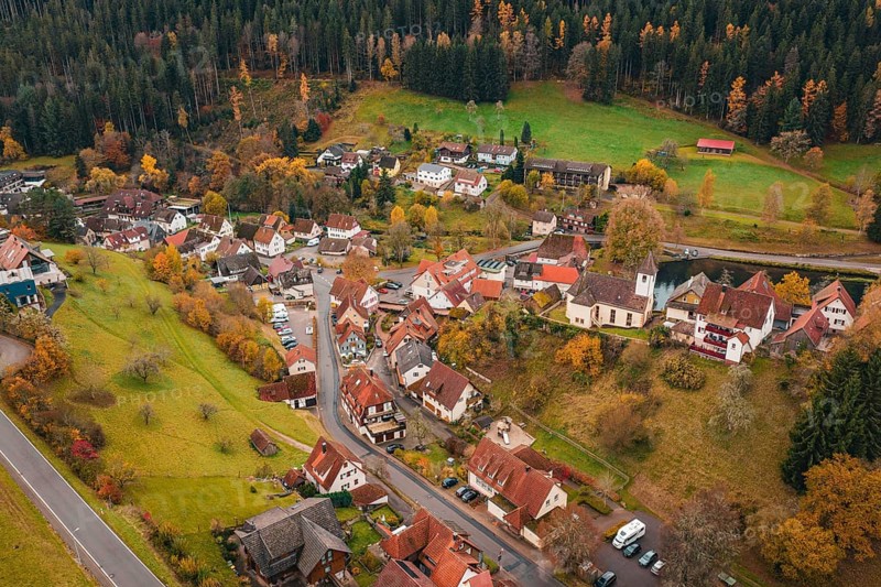 A small village with a church, surrounded by autumnal meadows and forests, Berneck Castle, Altentsteig, Calw district, Germany