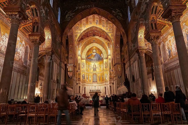 Magnificent sacral interior of a church with mosaics and golden decorations, filled rows of seats, Monreale, cathedral, UNESCO World Heritage Site, Sicily, Italy