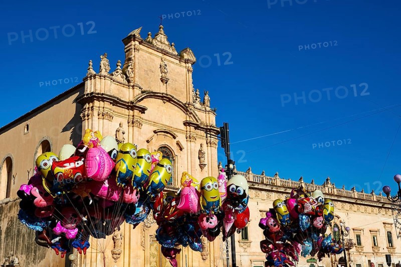 Scigli, Easter Sunday, glowing balloons floating in front of a church, standing out against the blue sky, Baroque towns of Sicily, Baroque corner of Sicily, late Baroque towns of Val di Noto, UNESCO World Heritage Site, Sicily, Italy