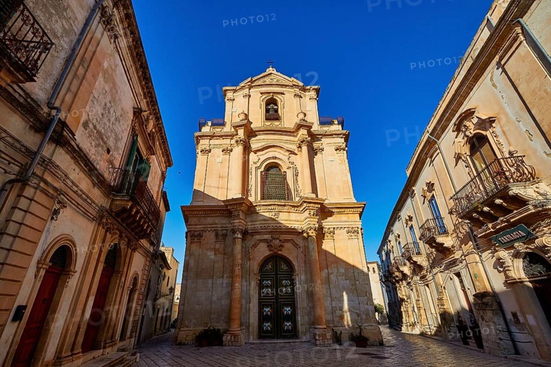 Scigli, beautiful baroque church surrounded by historic buildings in clear weather, Baroque towns of Sicily, Baroque corner of Sicily, late Baroque towns of Val di Noto, UNESCO World Heritage Site, Sicily, Italy