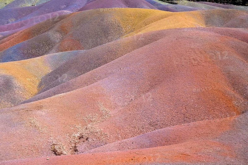 Rolling hills of colored sand form a unique landscape in rainbow colors. Africa, East Africa, Mauritius, Chamarel, Seven Coloured Earth