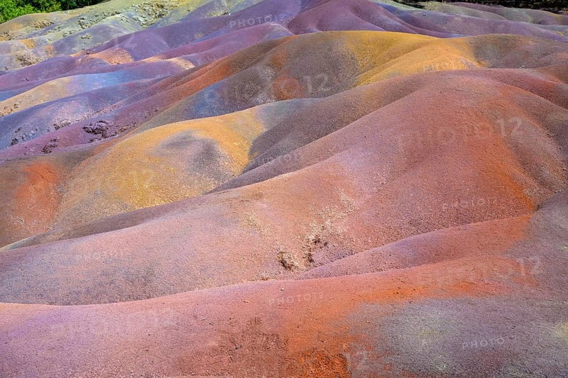 Bright multi-colored mounds of sand that form a wavy pattern. Africa, East Africa, Mauritius, Chamarel, Seven Coloured Earth