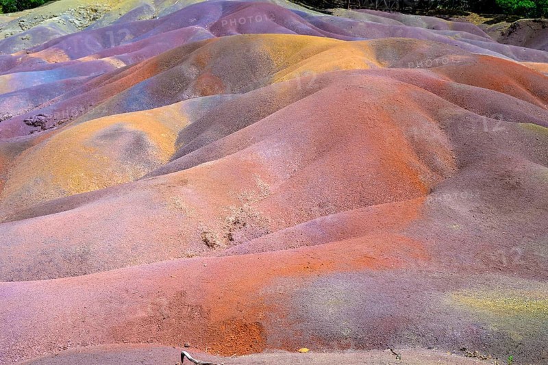 Colourful sand hills in bright orange and purple in a wavy pattern. Africa, East Africa, Mauritius, Chamarel, Seven Coloured Earth