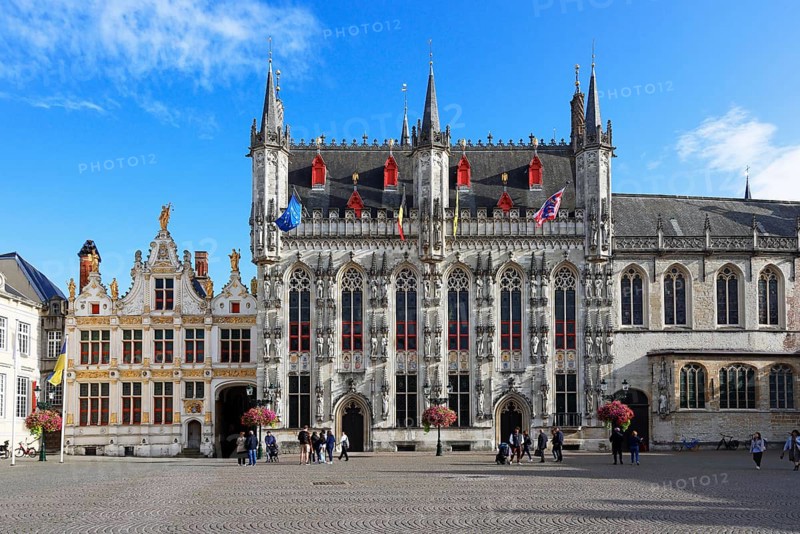 Historic Town Hall of Bruges on Castle Square, Stadhuis, (center of picture) as well as former court building today City Archive (left) and Basilica of the Holy Blood (right), Bruges, UNESCO World Heritage Site, Flanders, Belgium