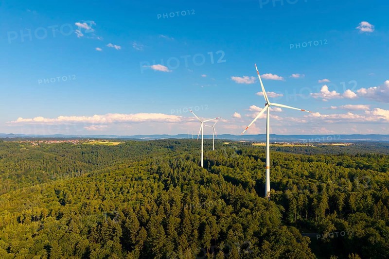 Wind turbines over green forest area, surrounded by beautiful clouds under a blue sky, near Schorndorf, Rems-Murr-Kreis, Baden-Württemberg, Germany