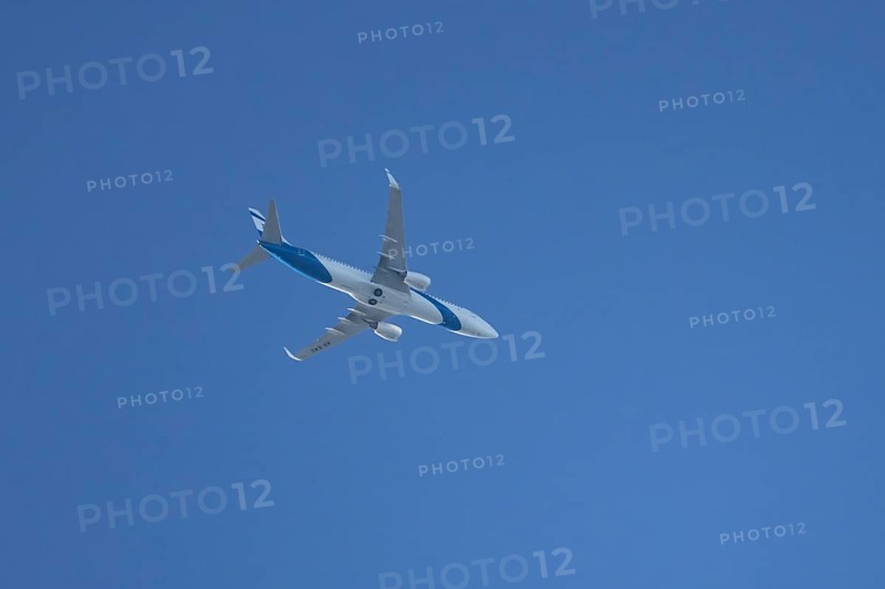 Boeing 737 jet passenger aircraft of El Al Israel airlines flying in a blue sky, England, United Kingdom