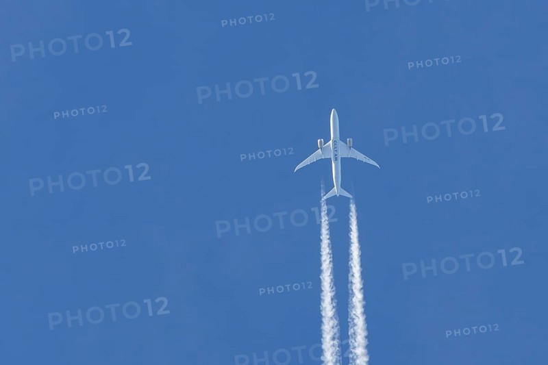 Boeing 787-9 Dreamliner jet passenger aircraft of Gulf Air airlines flying in a blue sky with contrails or vapour trails behind, England, United Kingdom