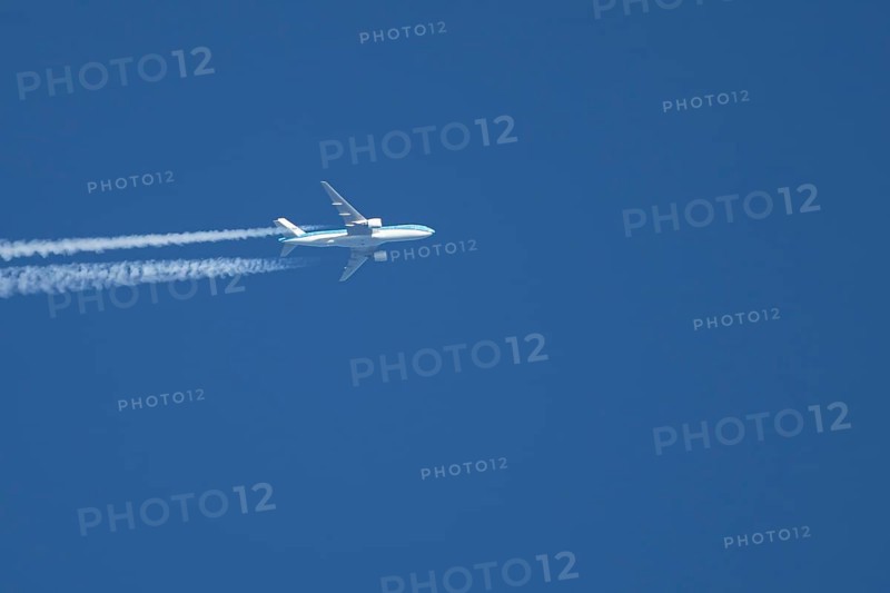 Airbus jet passenger aircraft of Royal Dutch KLM airlines flying in a blue sky with contrails or vapour trails behind, England, United Kingdom