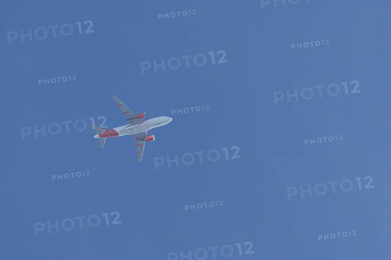 Airbus jet passenger aircraft of Easyjet airlines flying in a blue sky, England, United Kingdom
