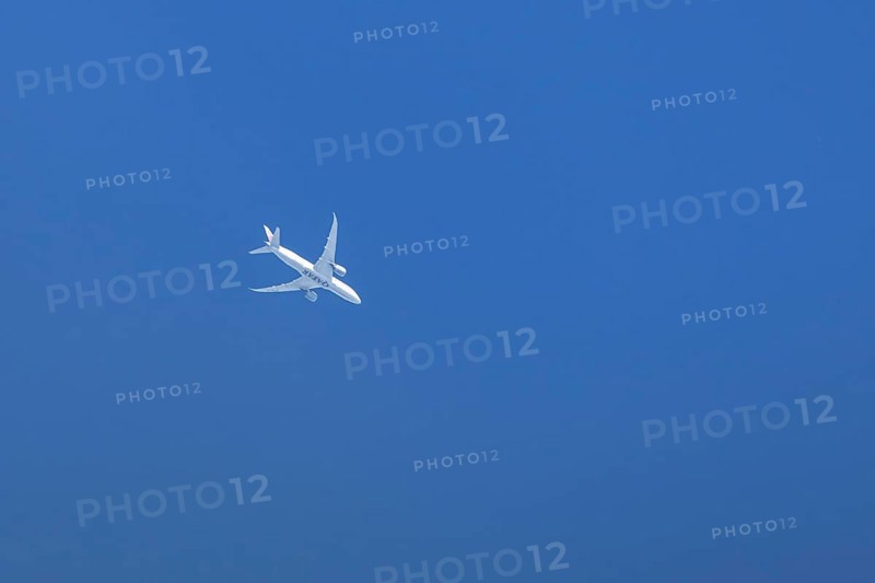Boeing 787-8 Dreamliner jet passenger aircraft of Qatar airways airlines flying in a blue sky, England, United Kingdom