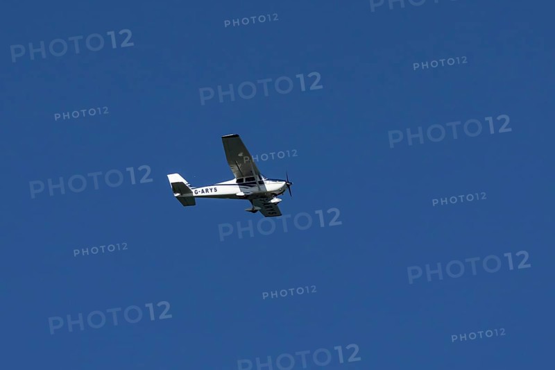 Cessna 172C Skyhawk aircraft flying in a blue sky, England, United Kingdom