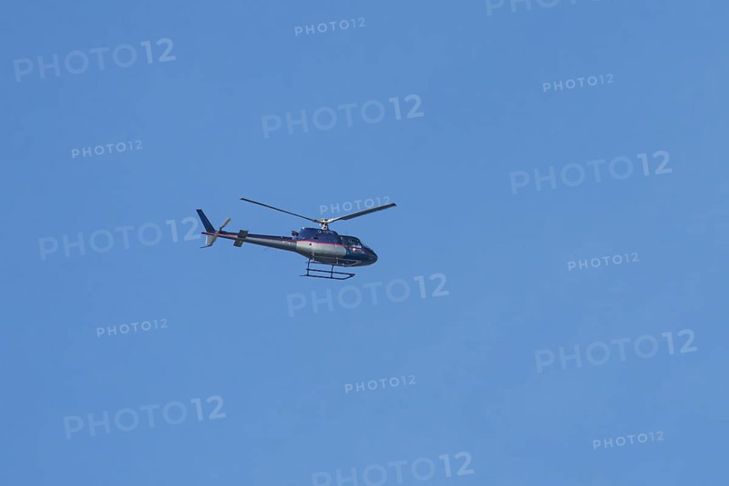 Airbus H125 helicopter flying in a blue sky, England, United Kingdom