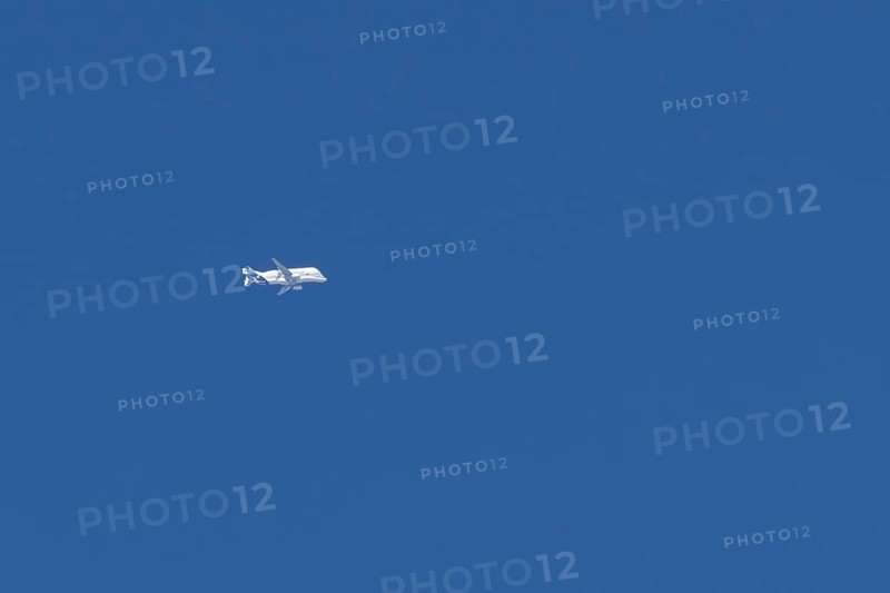Airbus A330-743L Beluga XL cargo jet aircraft flying in a blue sky with white clouds, England, United Kingdom