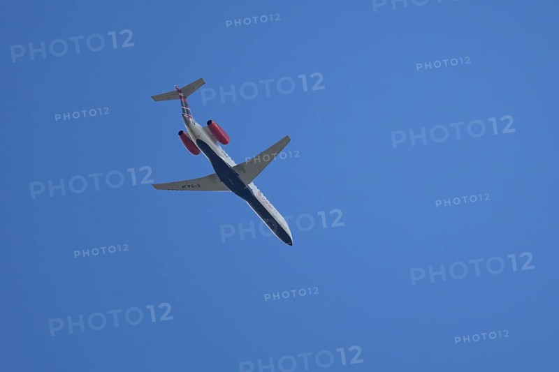 Embraer ERJ-145 jet passenger aircraft of Loganair airlines flying in a blue sky, England, United Kingdom