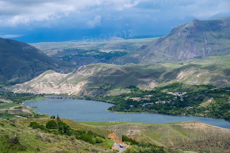 View of a lake nestled in mountainous landscape under cloudy sky, landscape with Shamb Reservoir near Ltsen, Vorotan River, Syunik Province, Syunik, Caucasus, Armenia