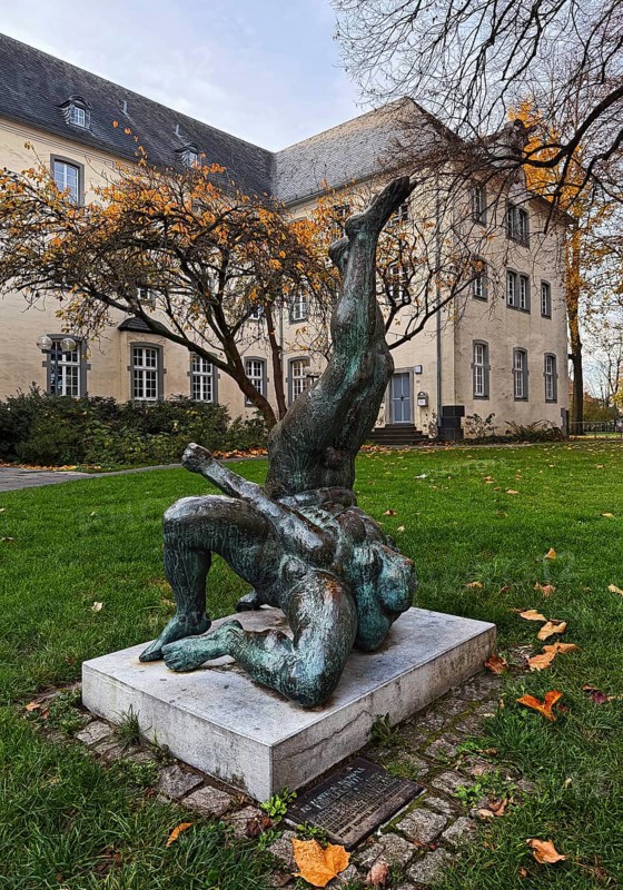 Sculpture entitled Wrestling Group by Jo Jastram in front of the former Kempen Franciscan monastery in autumn, Lower Rhine, Germany