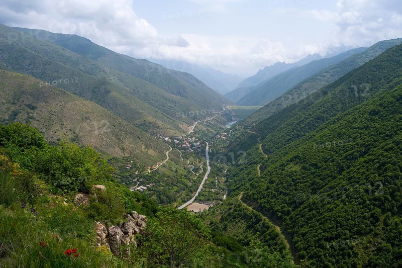 Extensive mountain landscape with a river surrounded by lush vegetation and clouds in the sky, view of Lernadzor, surrounded by the mountains of the Zangesur Range, Zangesur, Syunik Province, Caucasus, Armenia