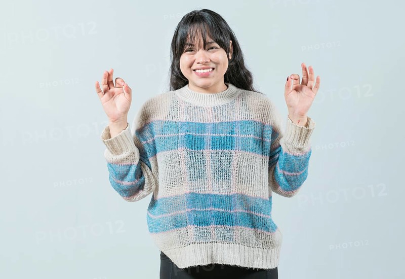 Smiling female interpreter gesturing OK in sign language. Smiling asian girl gesturing okay in language nonverbal