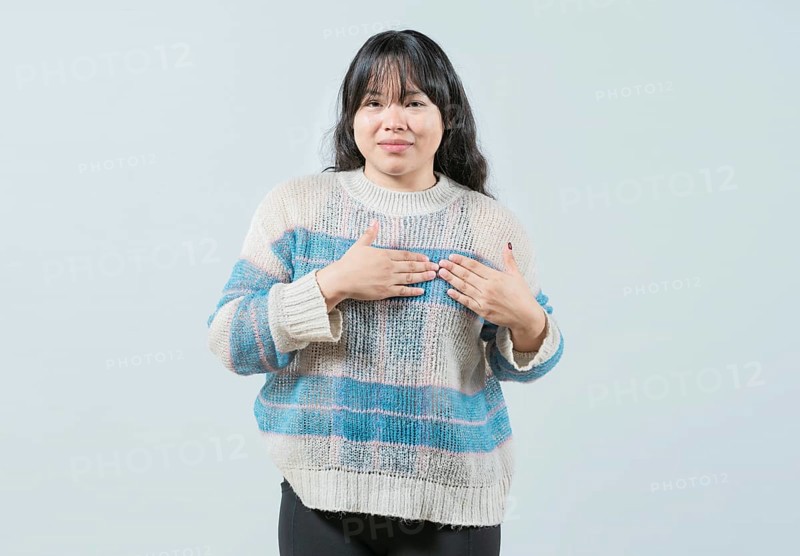 Asian girl gesturing GRATITUDE in sign language. Young woman making gesture GRATEFUL in sign language isolated