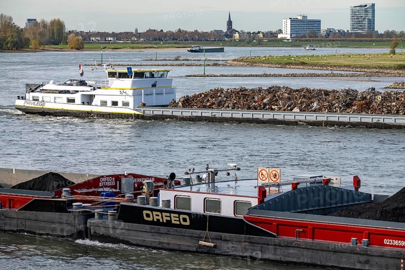 Dutch cargo ship Orfeo, brings power plant coal from the Netherlands to Mannheim, here on the Rhine near Düsseldorf, behind freighter with scrap metal, sails downhill, North Rhine-Westphalia, Germany