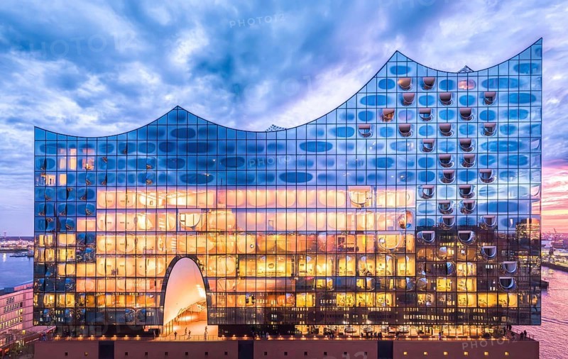 Aerial view of the Elbe Philharmonic Hall with reflections on the façade in the evening light above the harbor, Hamburg, Germany