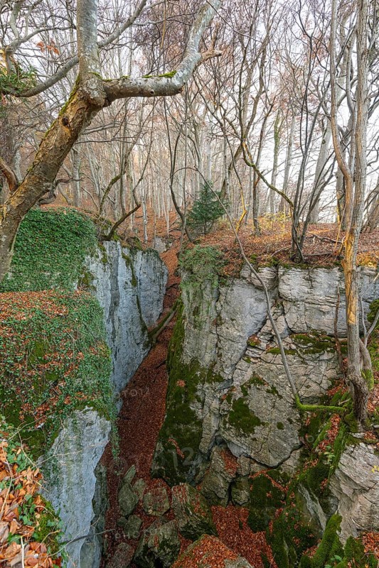 Low sun illuminates the rocks and caves of hell holes in the autumnal landscape of Dettingen an der Erms Baden-Württemberg Germany