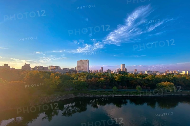 Japan, panoramic view of Osaka skyline from Osaka castle at sunset