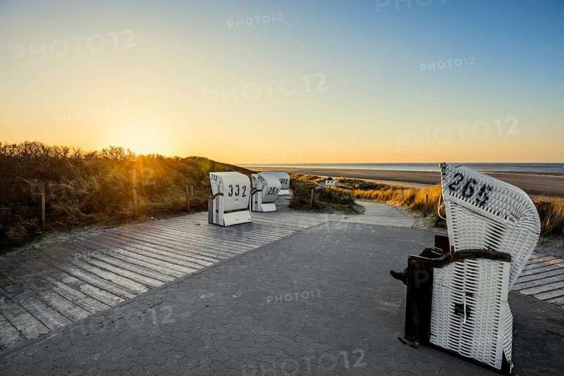 Beach chairs in the dunes and blue sky in winter, sunset, Spiekeroog, East Frisian Islands, Lower Saxony, Germany