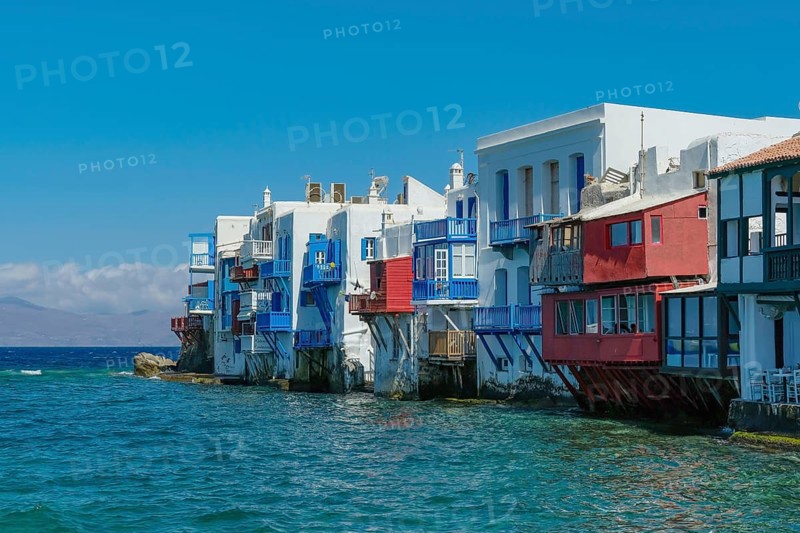 Mykonos, Cyclades, Greece - Little Venice is a picturesque neighborhood in Mykonos Town with colorful houses that stand right by the sea and are reminiscent of Venice. Little Venice is located on Alefkandra Bay next to the famous windmills of Mykonos. Mykonos is part of the Cyclades archipelago in the Aegean Sea