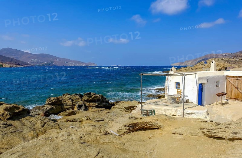 Mykonos, Cyclades, Greece - Ftelia Beach, fishing lodge on Ftelia beach, sandy beach on windy rocky coast in the north of the island