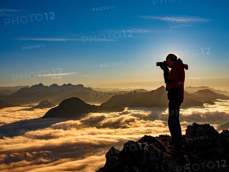 Photographer in evening light at the summit, view of an alpine panorama, Hochstaufen, Chiemgau Alps, Upper Bavaria, Bavaria, Germany