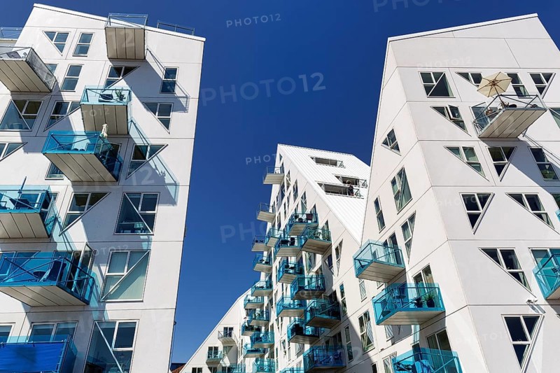 Distinctive white residential complex, turquoise balconies against blue sky, pyramid-shaped buildings, Isbjerget, iceberg, modern architecture in the harbor, Aarhus, Jutland, Denmark