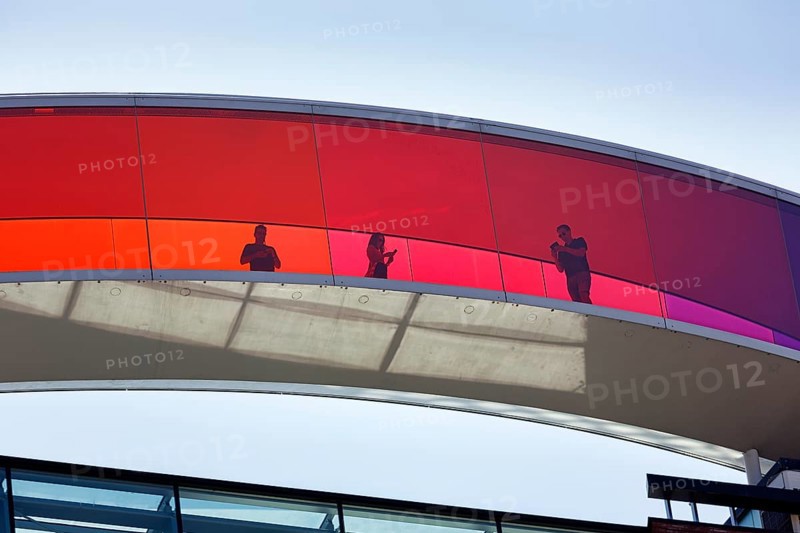 Colourful art installation Your Rainbow Panorama, artist Olafur Eliasson, ARoS, Aarhus art museum with roof installation and visitors, backlight, Aarhus, Jutland, Denmark