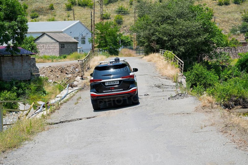 An SUV crosses a damaged bridge in a green, rural area, Toyota Fortuner on bridge over the Debed River, Ayrum, Tavush province, Tavush, Armenia