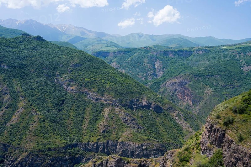Green mountains with scattered clouds in the sky, peaceful and natural surroundings, view from Halidzor observation deck towards the monastery, Tatev, Syunik province, Syunik, Armenia