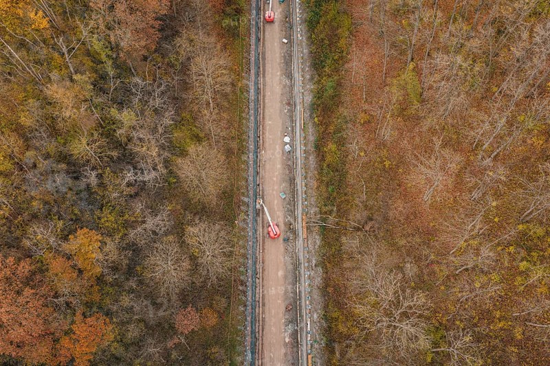 Aerial view of construction work along a slope in an autumn forest area, construction of the Hermann Hesse Railway, Im Hau, Calw, Germany
