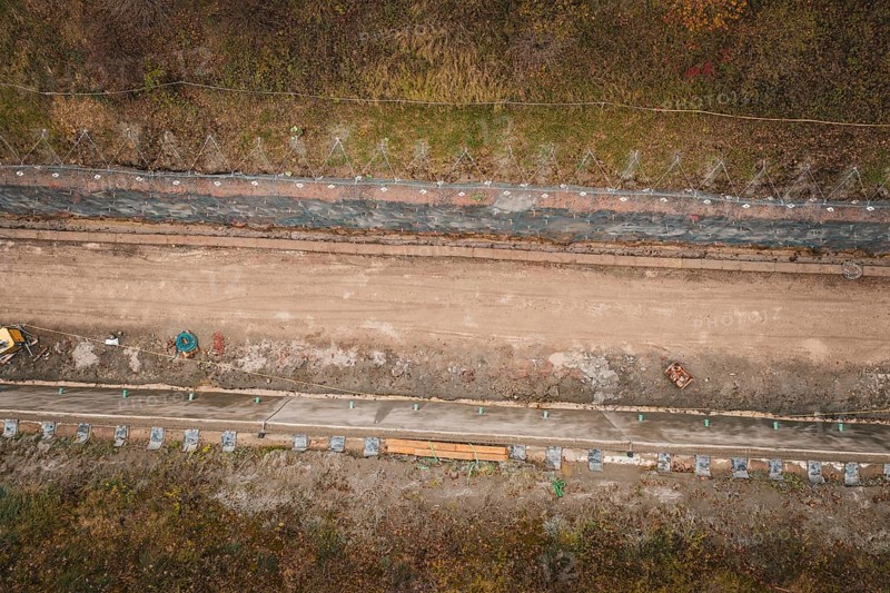 Aerial view of a construction site in an autumn area with construction along a path, construction of the Hermann Hesse Railway, Im Hau, Calw, Germany